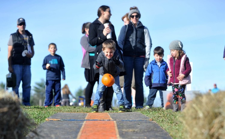 Isaac Provisor, 5, of Oakland, takes his turn at pumpkin bowling Saturday at the Fall Family Fun Day event at Quarry Road Trails in Waterville.