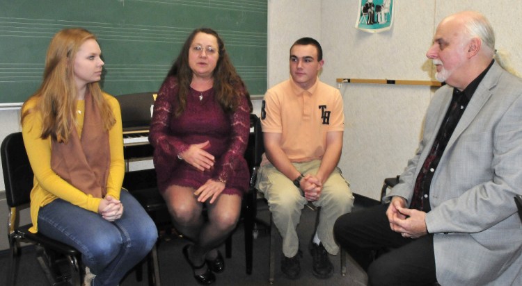 Messalonskee High School Concert Chorus director Pam Rhein speaks on Thursday with her husband and co-director Kevin and students Julia Cooke and Taylor Doone, who, along with other students, performed and made "Songs of Darkness and Hope." The recording has been nominated for a Grammy Award in the choral category.