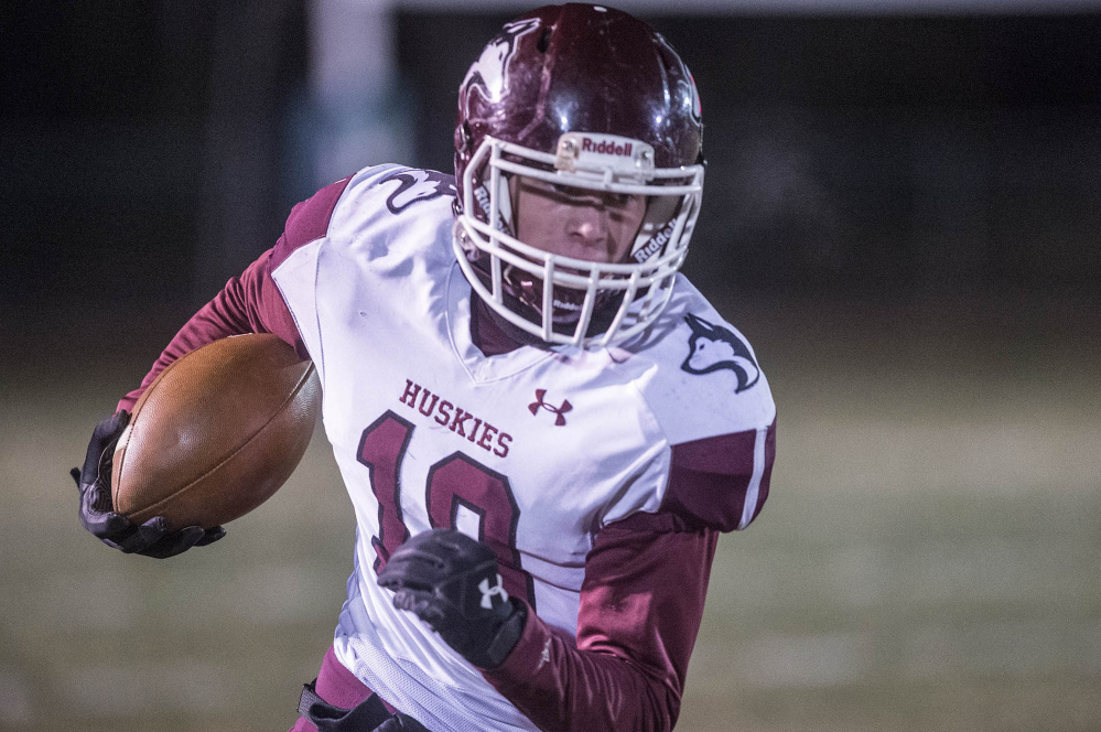 Maine Central Institute's David Young runs for extra yards during the Class C North championship game Saturday night in Bar Harbor.