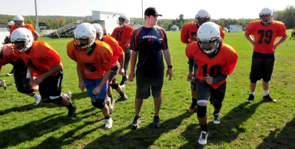 Skowhegan football coach Ryan Libby watches as his team goes through running drills during a pracrice earlier this season.