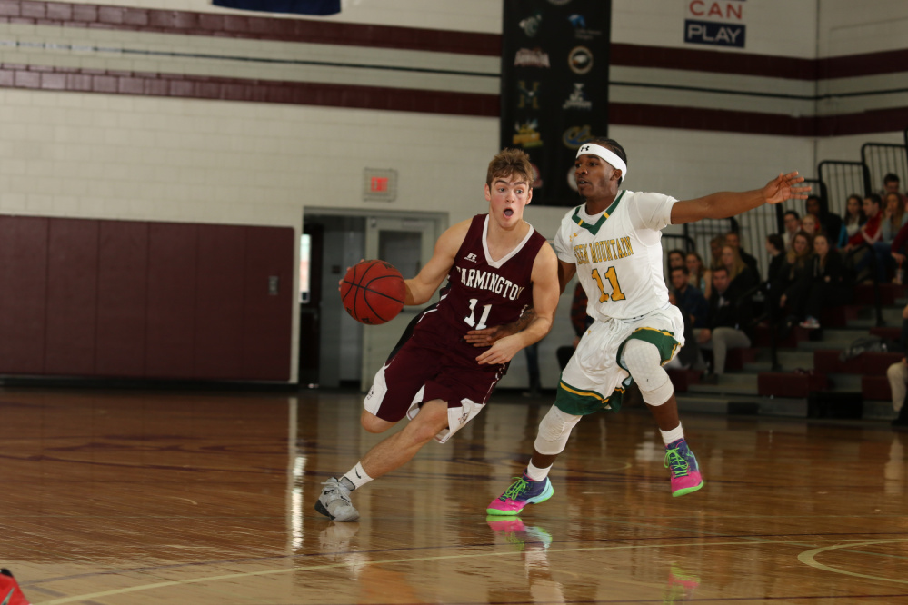 University of Maine at Farmington guard and Skowhegan native Issac Witham drives the lane during a game last season.
