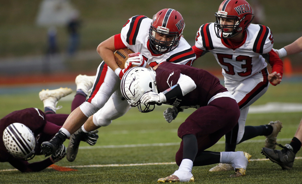 Foxcroft defenders bring down Wells fullback Nolan Potter during the Class D state championship game Saturday afternoon at Fitzpatrick Stadium.