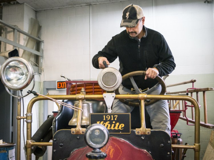 Augusta Fire Chief Roger Audette turns the siren crank on a 1917 White-Kress firetruck now in possession of the Augusta Fire Department.