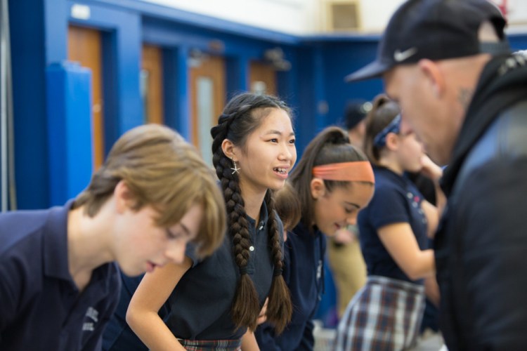 Eighth-grader Grace Hodgkin assists area residents in need at St. Michael School in Augusta on Monday during the annual distribution of Thanksgiving meal items.