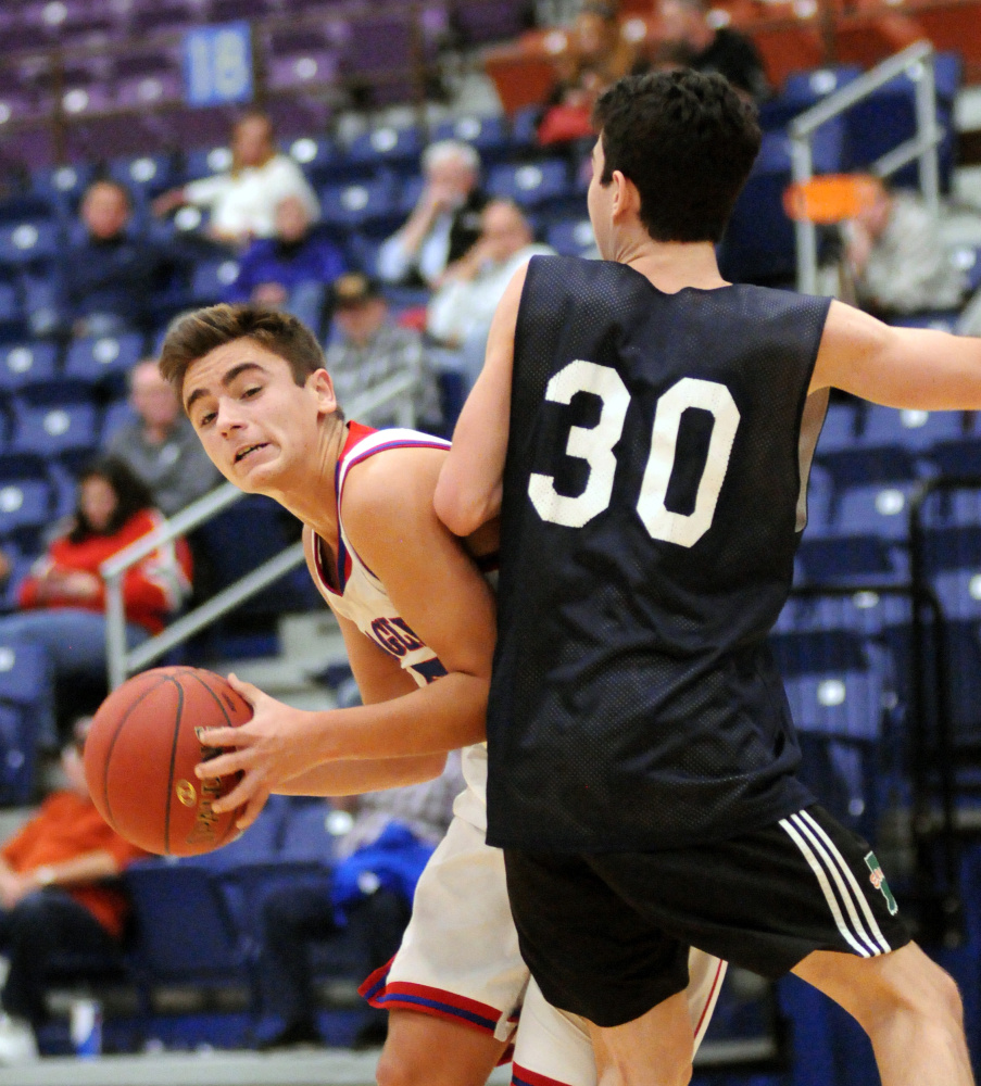 Messalonskee's Chase Warren, left tries to pass around Portland's Simon Chadbourne (30) on Friday at the Augusta Civic Center.