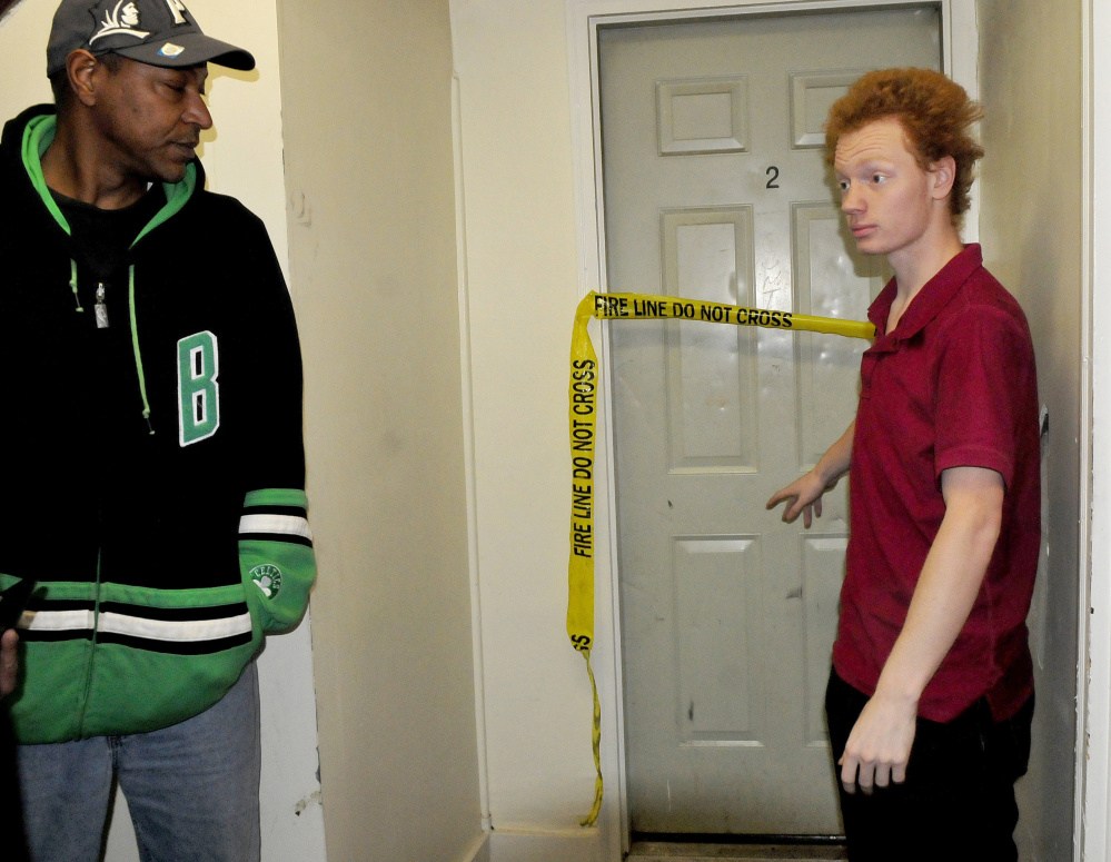 Paul Hodge, left, and tenant Stefan Buzzell speak outside the fire- damaged apartment 2 at 17 College Ave. in Waterville on Sunday. Fire damaged the apartment late Saturday evening and police arrested the tenant. Buzzell said the man entered his apartment 1 saying there was a fire and Buzzell called the fire department and began alerting neighbors by banging on doors and yelling fire. "When I opened the door of apartment  2 the door was hot and smoke poured out," Buzzell said.