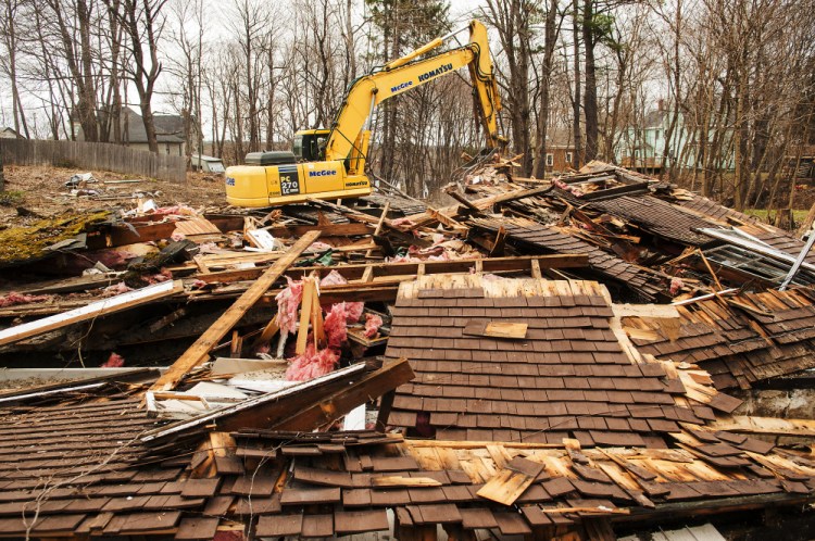 An excavator moves the demolished remains of 18 Dennis St. on April 19 in Gardiner. On Wednesday, City Council will consider whether to sell the now vacant lot to a neighbor.