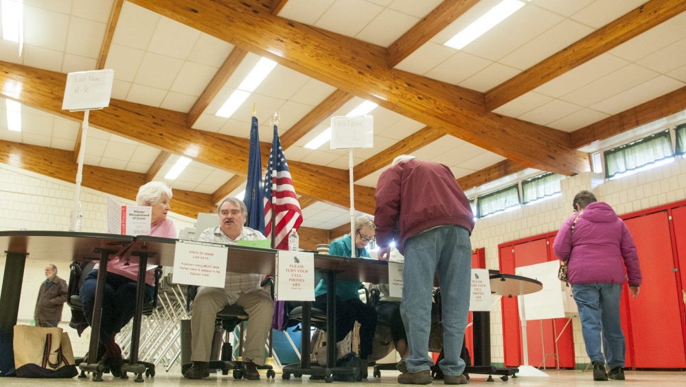 Voters come in to vote for a candidate to fill the one vacant City Council seat Tuesday at the Winthrop Town Office.