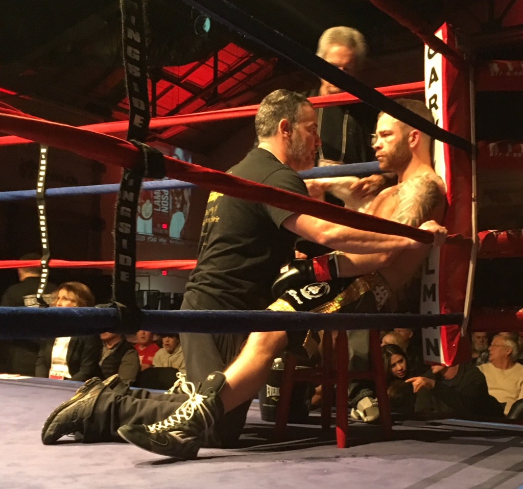 Brandon Berry, right, gets instructions between rounds during his bout with Eric Palmer of Uniontown, Pennsylvania, at the Portland Expo Saturday night.