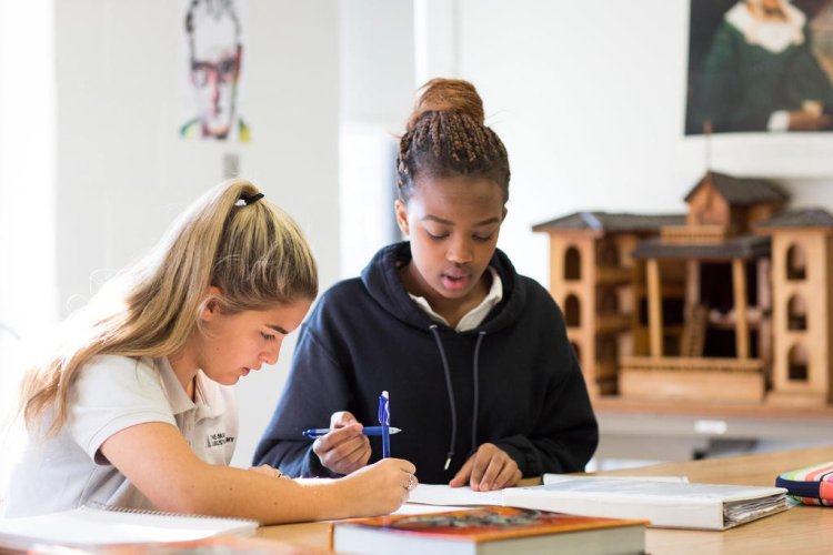 Enrollment at Maine Girls' Academy in Portland will expand when the school starts admitting seventh- and eighth-grade students next fall. Studying here are sophomores Victoria Silva, left, and Estella Mutoni.