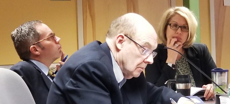 The team bringing the case against Dr. Jan Kippax for the state listens to testimony Saturday. From left, Assistant Attorneys General Jonathan Bolton and James Bowie, and Nancy Foster, a member of the Maine Board of Dental Practice who is not among those deciding the case.