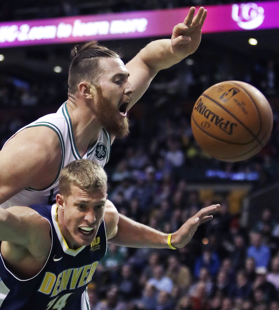 Celtics center Aron Baynes battles Nuggets center Mason Plumlee for a rebound in the first quarter.