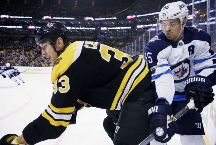 Boston's Zdeno Chara and Winnipeg's Mark Scheifele battle along the boards in the first period Thursday night in Boston.