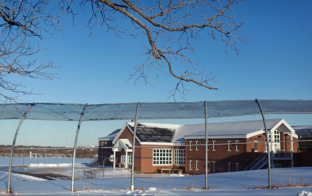 Long Creek Youth Development Center seen through the large fence that surround its outside grounds. A wide-ranging assessment of the center found serious deficiencies. (Staff photo by Brianna Soukup/Staff Photographer)