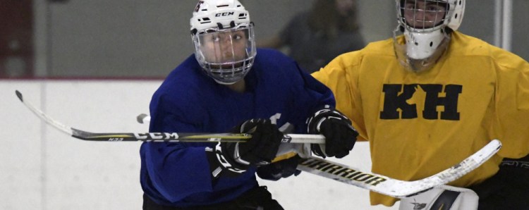 Cam Wilson, left, skates in front of the net Tuesday during hockey practice at Kents Hill School in Readfield.