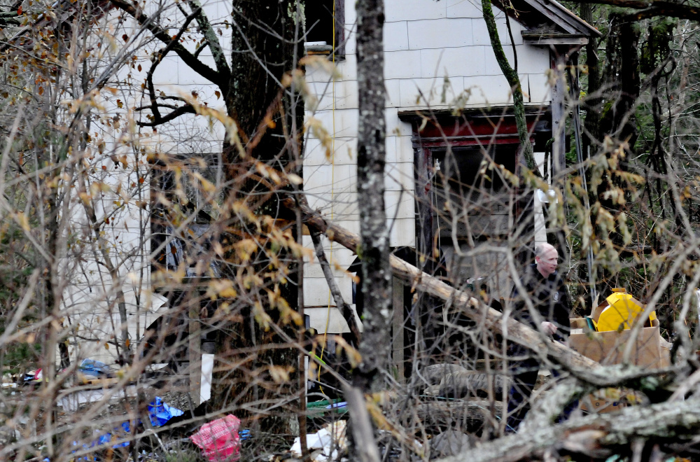 An investigator with the Maine State Police leaves a run-down home surrounded with discarded appliances Wednesday off Route 150 in Skowhegan. Police searched the building and a nearby mobile home Tuesday for any clues about the disappearance of Tina Stadig, who has been missing for nearly six months.