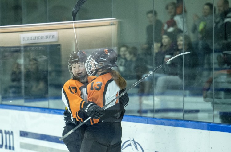 Winslow/Gardiner's Sarah Stevens, right, celebrates her first period goal with teammate Evelyn Hinkley on Wednesday at Colby College in Waterville.