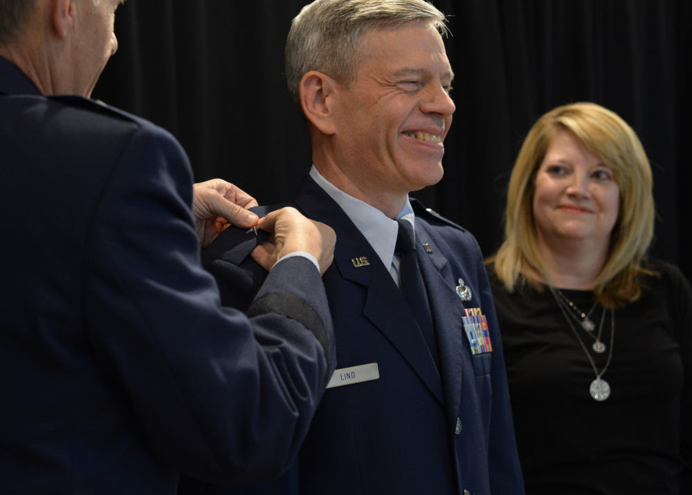 Brig. Gen. Douglas A. Farnham, adjutant general of the Maine Air National Guard, left, pins brigadier general rank onto Eric W. Lind, center, at a Dec. 1 ceremony in Augusta. Lind's wife, Sandra, right, participated in the promotion ceremony. Lind was named the assistant adjutant general of the Maine Air National Guard.