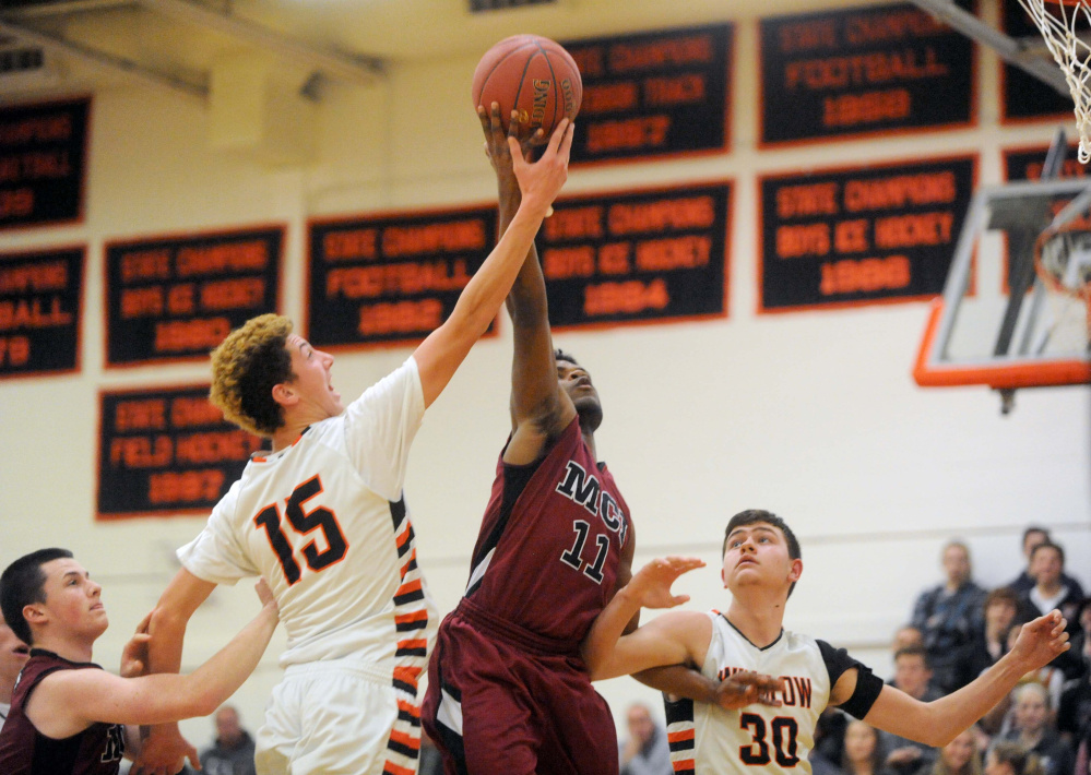 Not so fast: Winslow's Jack Morneault (15) tries to block a shot from Maine Central Institute's Pedro Matos during a Class B game last season in Winslow.