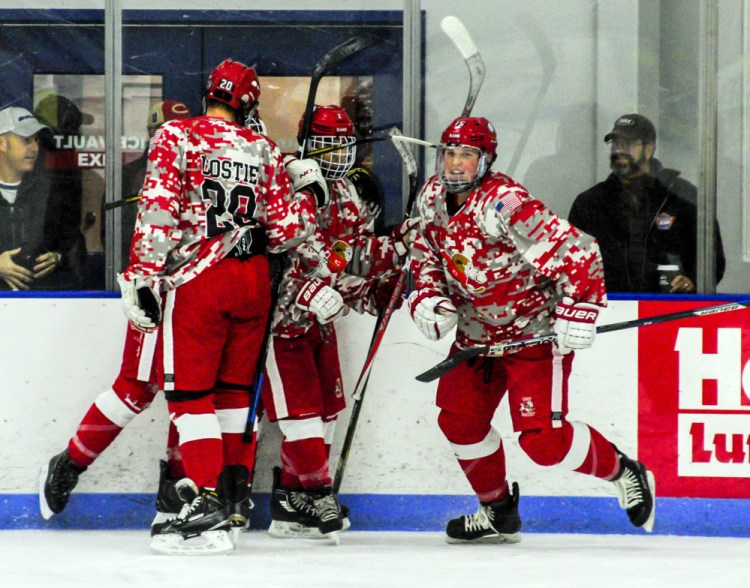 Cony celebrates after Cole Lockhart, right, scored the first goal for the Rams against Gardiner on Saturday  at the Camden National Bank Ice Vault in Hallowell.