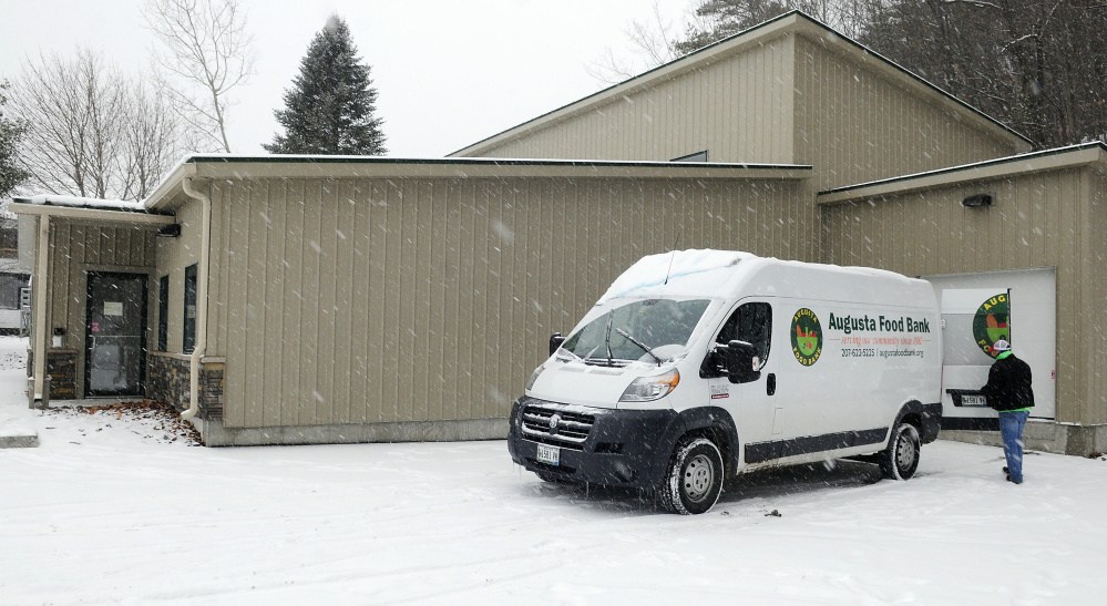 Warehouse manager Andy Waller closes a door of the Augusta Food Bank van Tuesday outside the new Augusta Food Bank in Augusta. He was moving food from the group's old warehouse to this new one.