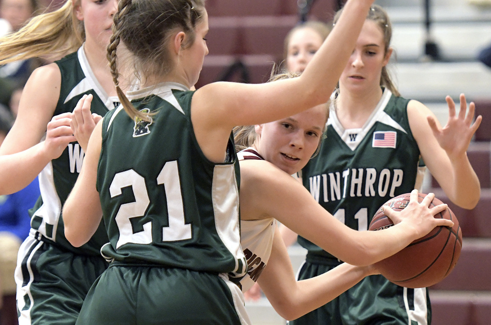 Richmond's Caitlin Kendrick looks for an opening around Winthrop defenders during a Class C South game Wednesday in Richmond.