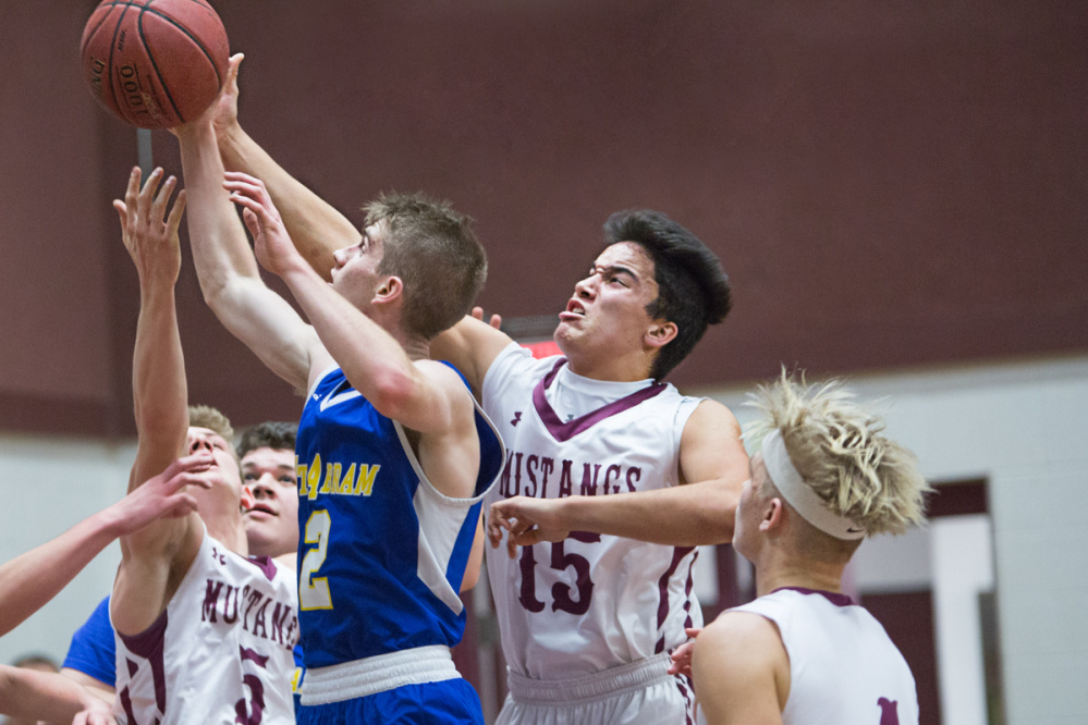 Mt Abram's Evan MacKay (2) grabs a rebound while Monmouth's Brock Bates (15) and others scramble for the loose ball Thursday in Monmouth