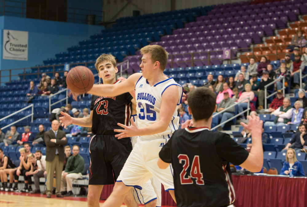 Madison's Max Shibley blocks a shot from Hall-Dale's Ashtyn Abbott at the Maine Gold Rush Invitational Tournament on Tuesday at the Augusta Civic Center.