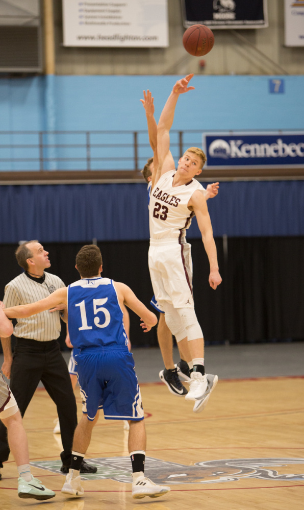 George Stevens Academy's Max Mattson (23) tips off the game against Erskine Academy at the Maine Gold Rush Invitational Tournament on Tuesday at the Augusta Civic Center.