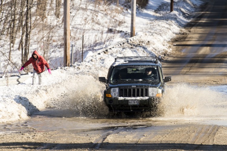 A water main break on Wednesday floods parts of Mayflower Hill Drive in Waterville.