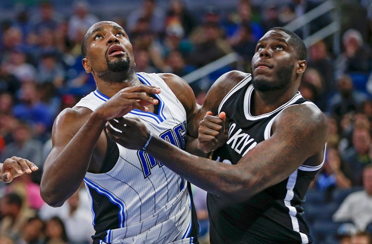 Then-Brooklyn Nets forward Anthony Bennett, right, battles Orlando Magic forward Serge Ibaka for a rebound during a game in Orlando on Dec. 16, 2016.