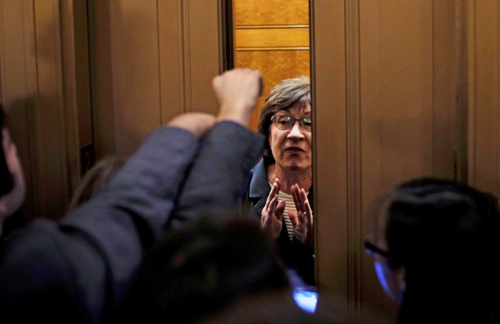 Sen. Susan Collins  speaks to reporters as she leaves the Senate floor Nov. 30.