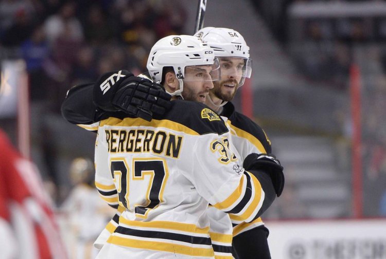 Boston's Patrice Bergeron celebrates a goal with Adam McQuaid in March.