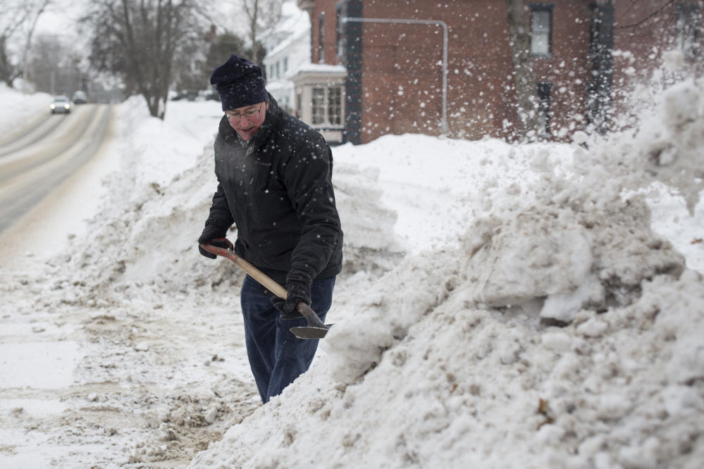 Mark Fisher shovels snow out of the way to widen his driveway in the single digit temperatures on Saturday. Inland Maine could see record breaking cold overnight on Saturday into Sunday.