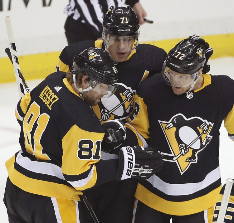 Pittsburgh Penguins' Phil Kessel celebrates his goal with Evgeni Malkin and Patric Hornqvist during the first period Sunday. Associated Press/Gene J. Puskar