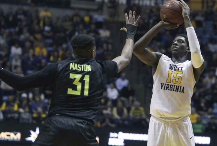 Lamont West of West Virginia shoots while being defended by Terry Maston of Baylor during the second half of West Virginia's 57-54 victory Tuesday night. The Mountaineers have the nation's longest winning streak at 15.
