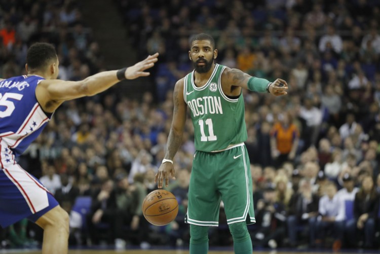 Boston's Kyrie Irving is guarded by Philadelphia's Ben Simmons during Thursday's game at the O2 Arena in London.