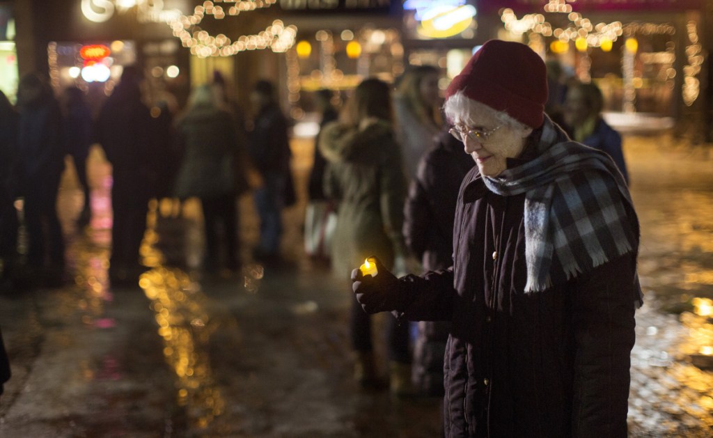 Sister Lucille Gardner holds a candle during a vigil Thursday in support of National Human Trafficking Awareness Day in Monument Square. Hope Rising, which held the vigil, is a residential treatment program in Penobscot County that serves victims of human trafficking.