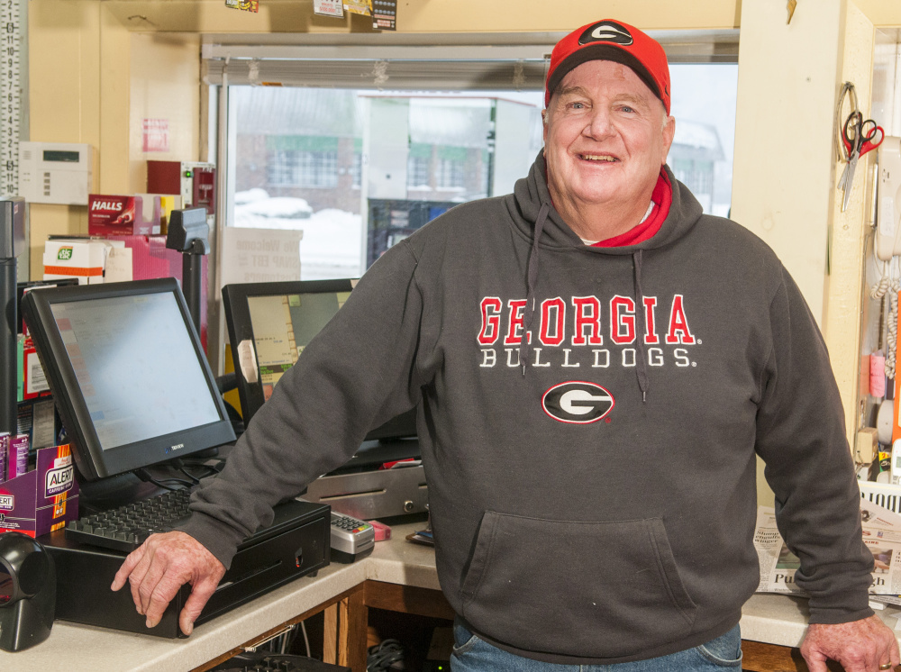 Cony assistant football coach Bob Lippert wears his University of Georgia gear to his job at an Augusta gas station Thursday. He was a walk-on player for their football team his freshman year there.