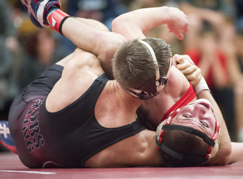 Nokomis High School's David Wilson, left, tries to pin Dexter High School's Tyler Bean, right, in the semifinals of the Warrior Clash on Saturday at Nokomis High School in Newport.