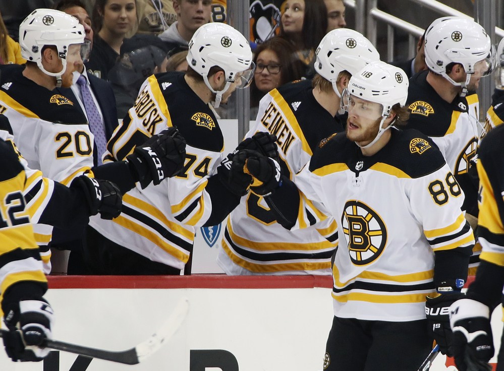 Boston Bruins forward David Pastrnak (88) returns to the bench after scoring in the second period of a game against the Penguins in Pittsburgh on Sunday.