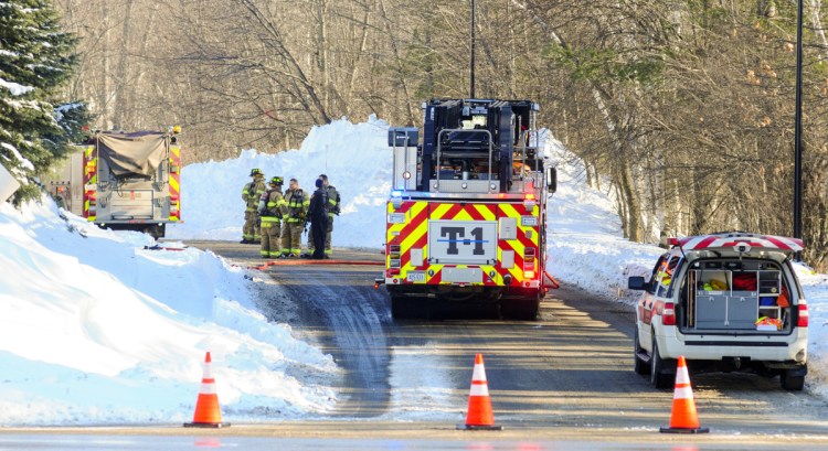 Augusta firefighters confer Tuesday morning after putting out a propane tank fire behind American Eagle Outfitters.