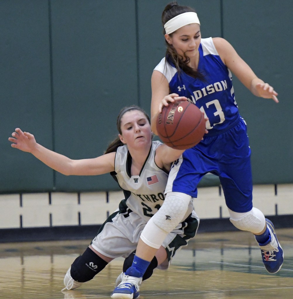 Winthrop's Katie Perkins, left, strips the ball from Madison's Emily Edgerly during a Mountain Valley Conference game Tuesday in Winthrop.