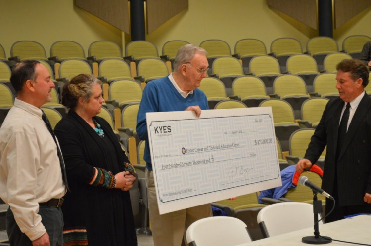 Richard T. Bjorn of Farmington, second from right, owner of Kyes Insurance Agency, is donating $470,000 over the next two years to fund career and technical education programs at Foster Career and Technical Education Center at Mt. Blue Campus in Farmington. Taking part in the presentation Tuesday at the RSU 9 board meeting are, from left, Glenn Kapiloff, director of Franklin County Adult and Community Education; Melissa Williams, director of Foster Tech; Bjorn; and Superintendent Tom Ward.