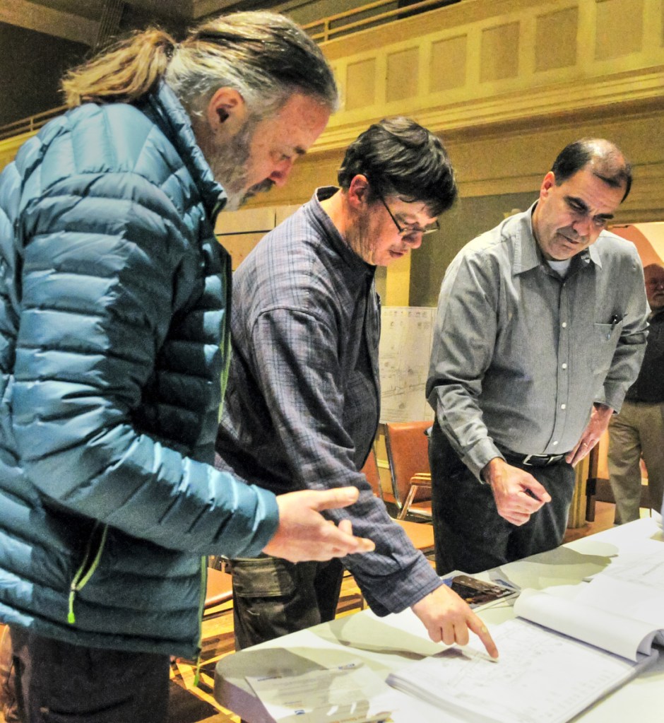 Alfred Lund, owner of The Center for Health Insight, left, and Geoff Houghton, owner of The Liberal Cup, ask questions Wednesday in Hallowell City Hall of Ernie Martin, Department of Transportation project manager. The discussion occurred during an open house about a pending Water Street reconstruction project.