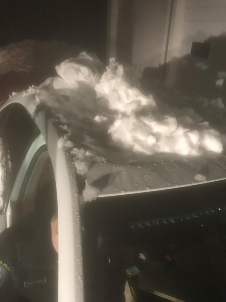 A Capitol Police cruiser is seen Thursday after snow and ice slid off the roof of a state-owned building and crushed the vehicle.