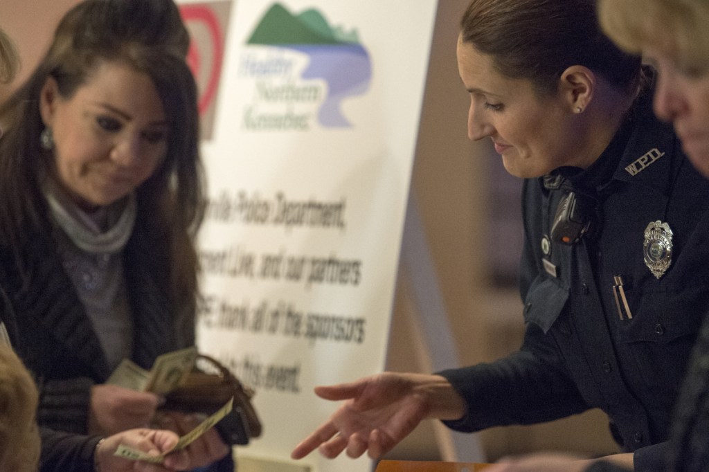 Linda Svedberg, right, a patrol officer with the Waterville police department, sells raffle tickets to Helen Bell-Necevski, at the Operation HOPE benefit concert at the Elk's Lodge in Waterville on Saturday. The benefit was used to raise money for people suffering substance abuse disorder.