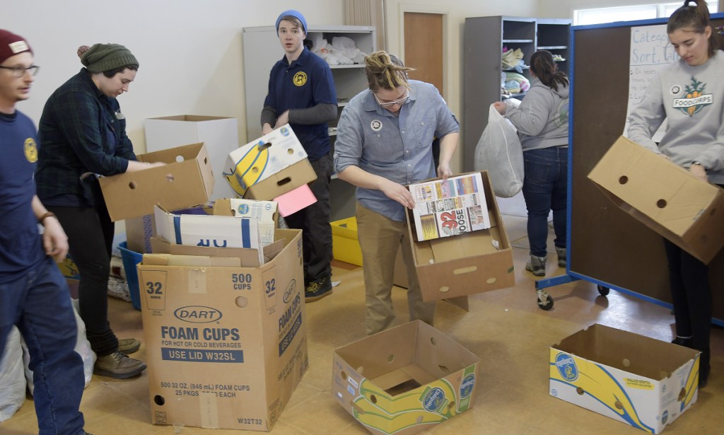 Maine Conservation Corps members volunteer at the Augusta Community Warming Center on the Day of Service for Martin Luther King Jr. on Monday.