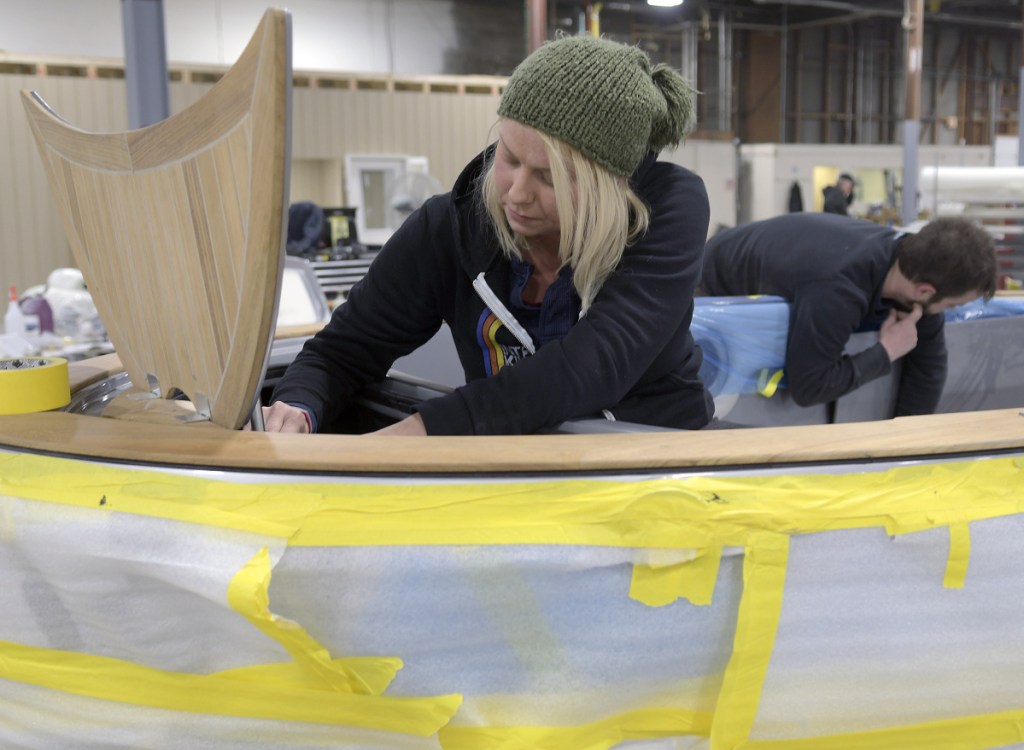 Molly Edwards and Aaron Arsenault work on a Carbon Craft tender at Southport Boats on Monday in Gardiner. Formerly part of Augusta's Kenway Corp., Southport has relocated to Gardiner under new ownership and will continue to produce its line of powerboats there.