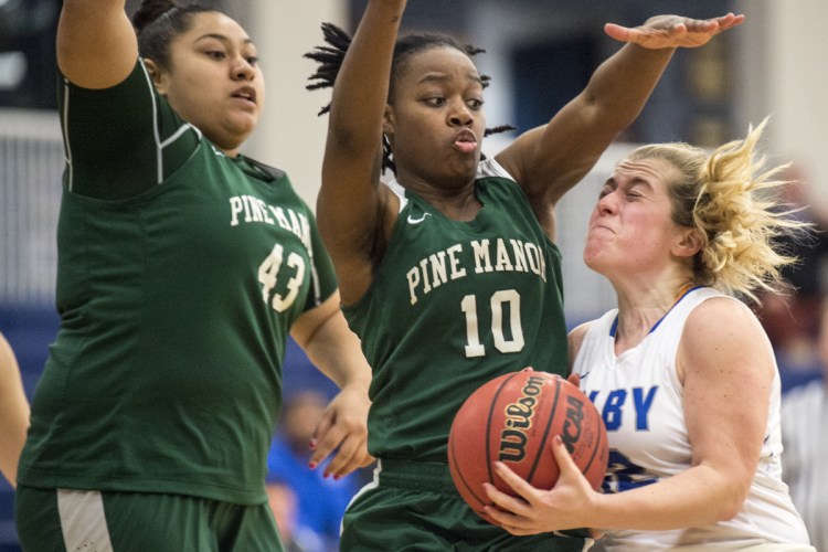Colby College's Sarah Hancock, right, draws the foul from Pine Manor College's Kayleigh Merrell (10) on Tuesday at Colby College in Waterville.